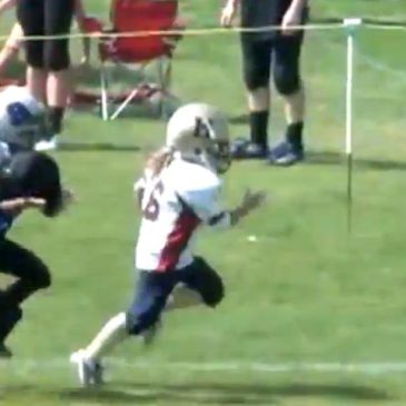 High Schooler Catches His Own Football Throw Across The Yard